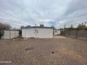 Exterior view of home and gravel backyard, featuring an external storage shed on the side at 7139 E Arcadia Cir, Mesa, AZ 85208