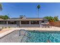 Backyard with an in-ground swimming pool, patio, and outdoor dining area at 7727 E 4Th St, Scottsdale, AZ 85251