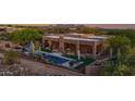Desert home showcasing a beautiful backyard pool with landscaping, patio, and mountain views at 8300 E Lone Mountain Rd, Scottsdale, AZ 85266