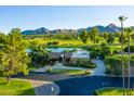 Beautiful house with golf course and mountain views, mature trees, and manicured landscaping on a sunny day at 8312 N Golf Dr, Paradise Valley, AZ 85253