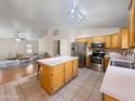 Open-concept kitchen featuring an island, stainless steel appliances, and hardwood floors at 8339 W Bluefield Ave, Peoria, AZ 85382