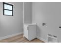 A functional mud room features a white cabinet and modern design at Xxx S Hunt Hwy, Queen Creek, AZ 85142