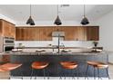 Kitchen island with modern pendant lights and breakfast bar seating at 10134 E Talon Ave, Mesa, AZ 85212