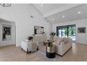 Bright living room with high ceilings, neutral decor, and sliding glass doors to the pool at 10360 N 98Th St, Scottsdale, AZ 85258