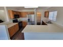 Bright kitchen featuring stainless steel appliances, laminate countertops, and a pantry at 10521 W Toronto Way, Tolleson, AZ 85353