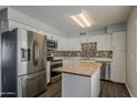 Modern kitchen featuring stainless steel appliances, white cabinets, and butcher block island at 11210 S Bannock St, Phoenix, AZ 85044