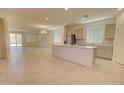 Open-concept kitchen with a center island, stainless steel appliances, and tiled floors at 1122 E Meadowbrook Dr, Casa Grande, AZ 85122