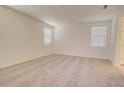 Spacious bedroom featuring neutral carpet, light colored walls, and two windows that provide great natural light at 1123 E Meadowbrook Dr, Casa Grande, AZ 85122