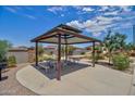 Community picnic area featuring a shaded gazebo, picnic tables, a playground, and desert landscaping at 1123 E Meadowbrook Dr, Casa Grande, AZ 85122