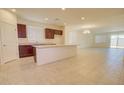 Bright kitchen featuring granite countertops, dark wood cabinets, and a large island at 1130 E Atwood Dr, Casa Grande, AZ 85122