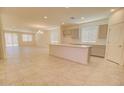 A spacious kitchen with a large island, neutral tones, modern appliances, and ample natural light at 1130 E Meadowbrook Dr, Casa Grande, AZ 85122