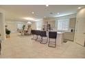 Open-concept kitchen featuring a center island with barstool seating and stainless steel appliances at 1130 E Meadowbrook Dr, Casa Grande, AZ 85122