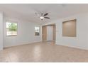 Bright living room with neutral tile flooring, ceiling fan, and natural light at 1202 E Binner Dr, Chandler, AZ 85225