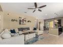 Bright living room featuring a sectional sofa, ceiling fan, and an open layout to the dining area at 1202 E Binner Dr, Chandler, AZ 85225