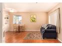 Bright living room includes wood-style floors, a dining table, and a comfortable seating area at 12221 W Bell Rd # 362, Surprise, AZ 85378
