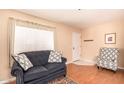 Cozy living room with a plush sofa, patterned chair, and a view of the entrance at 12221 W Bell Rd # 362, Surprise, AZ 85378