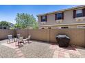 Private backyard with a gravel landscape, brick patio, and a grill, perfect for outdoor entertaining at 1265 S Aaron -- # 277, Mesa, AZ 85209