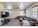 Large living room with neutral paint, carpeting, ceiling fan and a large sectional at 1265 S Aaron -- # 277, Mesa, AZ 85209