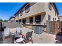 Back patio area with chairs and desert landscaping at 1265 S Aaron -- # 277, Mesa, AZ 85209
