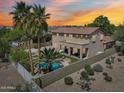 Aerial view of private backyard with a sparkling pool, lush tropical plants, and privacy fence at 1360 S Camellia Ct, Chandler, AZ 85286