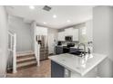 Bright kitchen featuring stainless steel appliances, and a view of the staircase leading to the upper level at 14907 N 177Th Ave, Surprise, AZ 85388