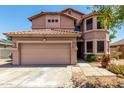 Two-story home with a neutral color scheme, well-maintained landscaping, and a two-car garage at 16527 N 71St Dr, Peoria, AZ 85382