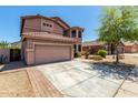Two-story home with a neutral color scheme, well-maintained landscaping, and a two-car garage at 16527 N 71St Dr, Peoria, AZ 85382