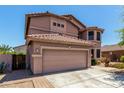 Two-story home with a neutral color scheme, well-maintained landscaping, and a two-car garage at 16527 N 71St Dr, Peoria, AZ 85382