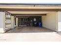 View of a covered carport featuring a beam pergola, painted posts, and an outdoor living area at 1982 E Oxford Dr, Tempe, AZ 85283