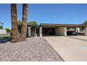 Charming home exterior featuring mature landscaping and a spacious covered carport for convenient parking at 1982 E Oxford Dr, Tempe, AZ 85283