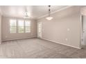 Bright living room with large windows, ceiling fan, carpet, and neutral walls, perfect for relaxation and comfort at 20100 N 78Th N Pl # 3212, Scottsdale, AZ 85255