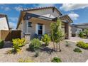 Inviting front yard with lush landscaping and a covered porch, creating a warm welcome at 20606 E Avenida Del Valle Ct, Queen Creek, AZ 85142
