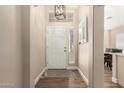 Inviting entryway featuring a pendant light, wood-look floors, and neutral paint at 2247 E Ross Ave, Phoenix, AZ 85024