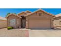Home exterior featuring a two-car garage, desert landscaping, and a neutral color palette at 2247 E Ross Ave, Phoenix, AZ 85024