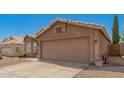 This home features a spacious two-car garage, desert landscaping, and a neutral color scheme at 2247 E Ross Ave, Phoenix, AZ 85024