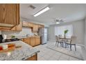 Bright kitchen featuring stainless steel appliances, granite countertops, and adjacent dining area at 2617 N 40Th Ave, Phoenix, AZ 85009