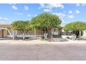 Charming single-story home featuring mature shade trees and accessible ramp, showcasing curb appeal at 2650 W Union Hills Dr # 100, Phoenix, AZ 85027