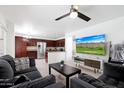 Comfortable living area with tile flooring, ceiling fan, and an adjacent kitchen at 31227 N 45Th St, Cave Creek, AZ 85331