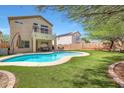 A beautiful backyard with a sparkling blue pool, green grass, and space for outdoor dining at 31227 N 45Th St, Cave Creek, AZ 85331