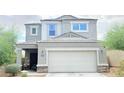 Lovely two-story home featuring desert landscaping and a two-car garage at 3402 N 300Th Dr, Buckeye, AZ 85396
