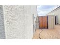 Well-maintained side yard with a wooden gate at 3402 N 300Th Dr, Buckeye, AZ 85396