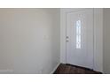 Entryway featuring white front door with decorative glass pane and hardwood flooring at 3405 W La Salle St, Phoenix, AZ 85041
