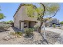 Two-story home with desert landscaping featuring mature tree and rock accents at 3405 W La Salle St, Phoenix, AZ 85041