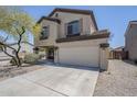 Two-story home featuring a two-car garage, neutral stucco, and desert landscaping at 3405 W La Salle St, Phoenix, AZ 85041