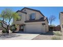 Two-story home featuring a two-car garage, desert landscaping, and neutral stucco exterior at 3405 W La Salle St, Phoenix, AZ 85041