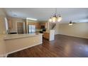 Open-concept living area with vinyl floors, and a view of the kitchen at 3405 W La Salle St, Phoenix, AZ 85041
