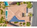 Aerial view of home featuring a pool, spa, patio seating and solar panels at 36298 N Crucillo Dr, Queen Creek, AZ 85140