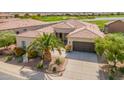 Aerial view of home featuring landscaping, a three car garage and desert views at 36298 N Crucillo Dr, Queen Creek, AZ 85140