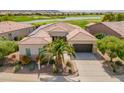 Aerial view of home featuring landscaping, a three car garage and desert views at 36298 N Crucillo Dr, Queen Creek, AZ 85140