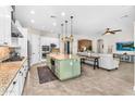 Bright, open kitchen with a center island, modern appliances, and tile floors at 3872 E Jude Ln, Gilbert, AZ 85298